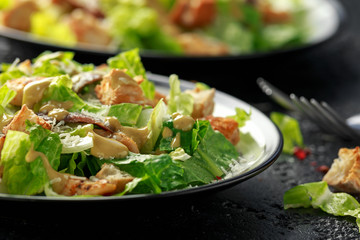 Caesar salad with chicken, anchous fish, croutons, parmesan cheese and greens. healthy food - obrazy, fototapety, plakaty