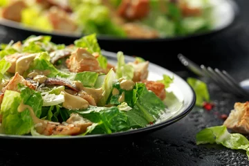 Poster Caesar salad with chicken, anchous fish, croutons, parmesan cheese and greens. healthy food © grinchh