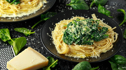 Tagliatelle pasta with spinach in cream sauce with parmesan