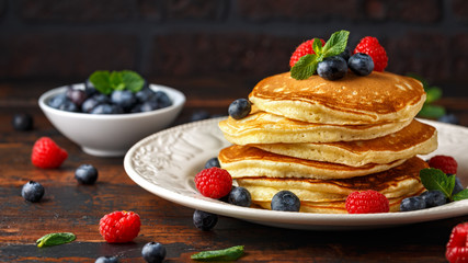 Homemade american blueberry, raspberries pancakes. Healthy morning breakfast. rustic style.