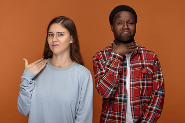 I'm fed up. Annoyed displeased young woman of European appearance posing isolated in studio with...