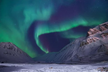 Fotobehang The polar arctic Northern lights aurora borealis sky star in Norway travel Svalbard in Longyearbyen city the moon mountains © bublik_polina
