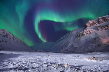 The polar arctic Northern lights aurora borealis sky star in Norway travel Svalbard in Longyearbyen city the moon mountains