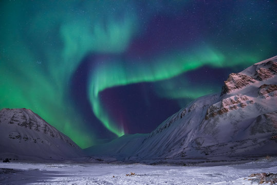 The polar arctic Northern lights aurora borealis sky star in Norway travel Svalbard in Longyearbyen city the moon mountains