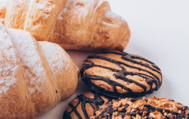 Breakfast with coffee, milk and croissants on wooden table