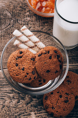 Breakfast with milk and cookies on wooden table