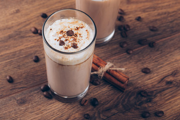 glass of milk and cookie on wooden background