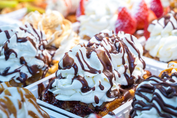 colorful cake sweet dessert with whipped cream at a street food market