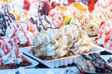colorful cake sweet dessert with whipped cream at a street food market