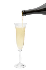 Champagne pouring from bottle in glass. Isolated on white.