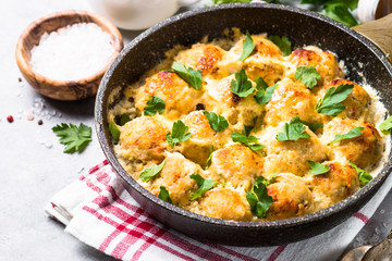 Meatballs in cream sauce with parmesan cheese.