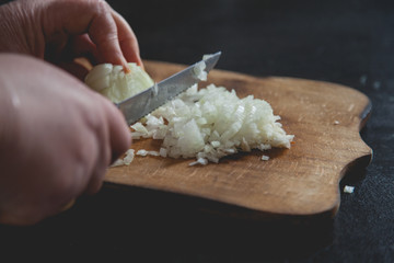 Obraz na płótnie Canvas cutting white onion with knife 