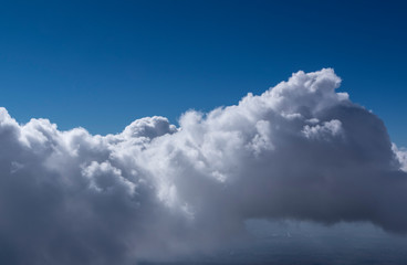 Obraz premium White cumulus clouds seen from top of volcano