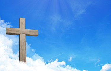 The cross of jesus and cloudful blue sky with copy space
