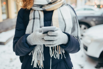 Young woman wearing warm coat and large scarf