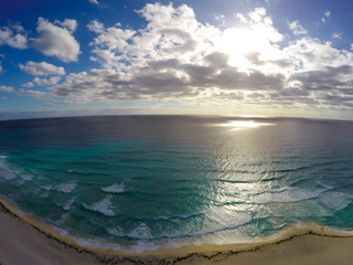 Playa Delfines, Cancun, Mexico. Aerial view on beach and coast of Caribbean sea against blue sky. Top view