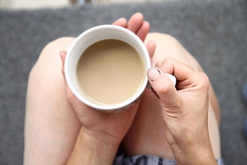 woman holding coffee cup