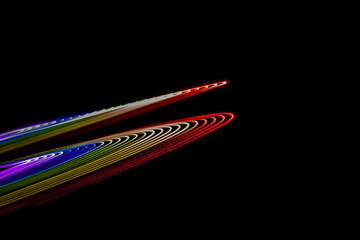 Abstract lines made with light painting with the colors of the rainbow on black background