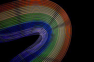 Abstract lines made with light painting with the colors of the rainbow on black background