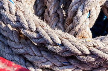 Fototapeta na wymiar A roll of old ship's ropes, illuminated by the sun.