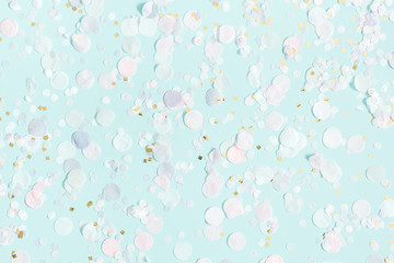 Paper confetti on pastel blue background. Party, birthday, wedding, holiday concept. Flat lay, top...