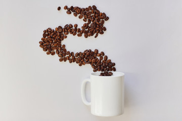 Cup of coffee and roasted coffee beans on white background, flatlay design