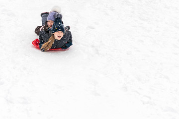 Fototapeta na wymiar children slide on ice-boats
