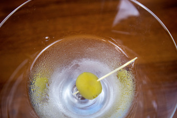 Dry martini cocktail with olive on toothpick