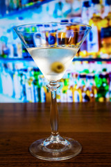 Dry martini cocktail with olive on toothpick