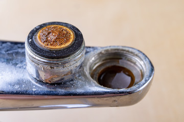 Old faucet for repair. Used hydraulic parts. Light background.