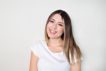 Fototapeta premium Portrait of young beautiful cute cheerful girl smiling looking at camera over white background.