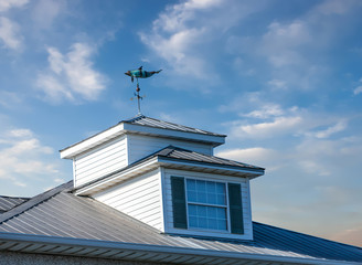 Windvane on Cupola on Blue Sky