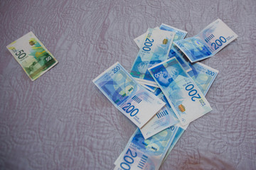 Israeli money stack of the new Israeli money bills banknotes of 200 and 50 shekel. New Israeli...
