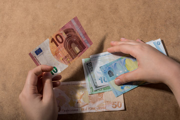 Hand holding American dollar  isolated on wooden background