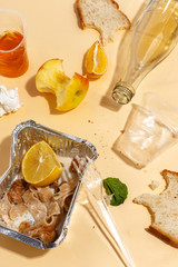 After banquet is finished. Wasted food on table after dinner party. Leftovers, empty plates, left half eaten food and meals. Top view