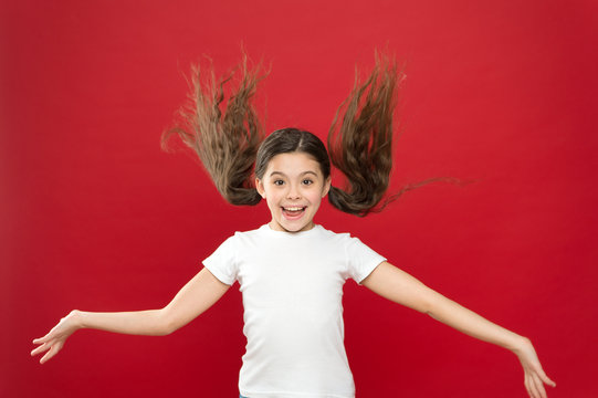 Beauty In Motion. Happy Little Girl With Stylish Ponytail Hairstyle. Little Child With Long Locks Of Hair. Small Model With Brunette Hair In Beauty Salon. Pretty Girl Smile With New Hairstyle