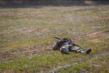 SAMBEK, ROSTOV REGION, RUSSIA, AUGUST 19, 2018: Historical festival Sambek Heights. Killed soldier of special purpose detachment with a gun in his hands lies on the battlefield
