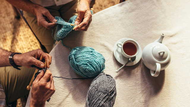 Senior people knitting at home