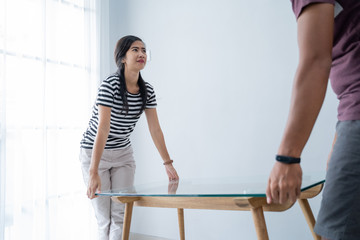a new couple brings a table to move interior furniture