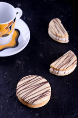 Delicious desserts on a black background. Cookies and marshmallows on the background. Fragrant dessert.