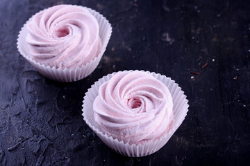 Delicious desserts on a black background. Cookies and marshmallows on the background. Fragrant dessert.