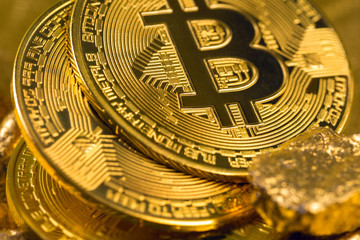 cryptocurrency golden coins - Bitcoin, Ethereum, Litecoin on the background of gold nuggets. Virtual money concept.