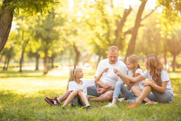 Fototapeta premium Young family with smiles and children in nature