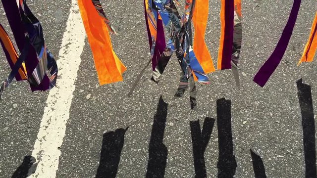 Colorful carnival streamers waving in the wind under bright Brazilian sunshine at a daytime banda street party in Rio de Janeiro, Brazil