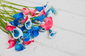 blue and pink flowers on white wooden background