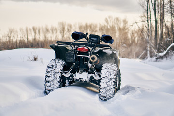 quad bike in a snowy forest © Дмитрий Ткачев
