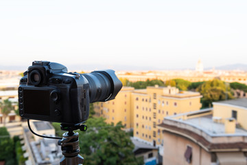 Italian town of Rome, Italy cityscape skyline with high angle view of architecture old buildings during sunset with generic camera on tripod
