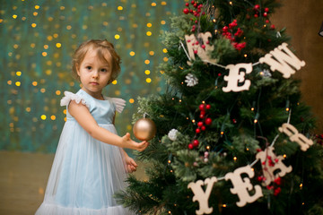 little girl under the christmas tree with christmas gifts