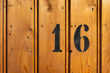 number 16 on door of storage room for tenants in century-old apartment building in stockholm
