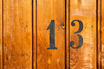 number 13 on door of storage room for tenants in century-old apartment building in stockholm